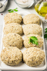 Raw meat fritters and ingredients on a cutting board, ready for cooking. Selective focus, space for text.