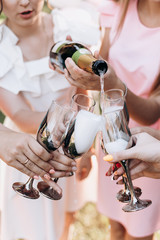 champagne is poured into glasses at the bachelorette party