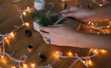 Hand made jewelry.  Woman packed a Christmas gifts on wooden table.