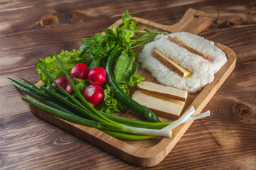 Mengrelian corn mamalica (ghomi) with cheese and various herb on wooden table. Georgian traditional food