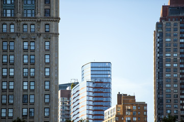 Close-up view of some huge buildings and beautiful skyscrapers in Manhattan, New York City, USA.