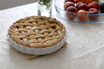 Homemade baked peach pie, served on a table. Selective focus.