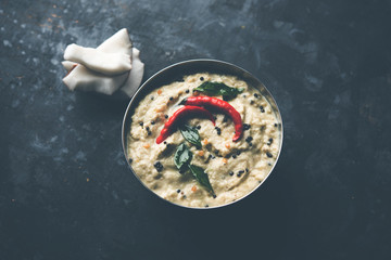Nariyal or Coconut Chutney served in a bowl. Isolated over moody background. selective focus