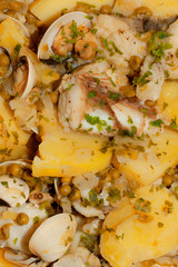 Detail of a monkfish dish with clams