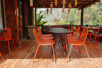Orange outdoor table & chairs in bistro caf&eacute; in daytime for relaxation, travel, season, time, holiday, gastronomy, concept