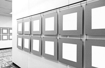 Art gallery with blank paper posters hanging on the walls. Black and white real image exhibition mockup 