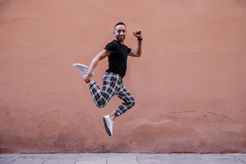 Fototapeta na wymiar Young boy jumping on the street