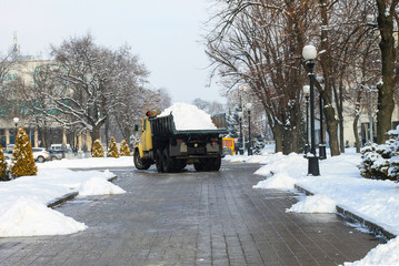 A large utility truck removes snow from a city street in winter. Dnipro city, Dnepropetrovsk, Dnipropetrovsk, Ukraine