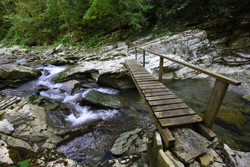 Bridge over the mountain river on the tourist trail at the 