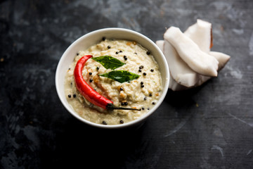 Nariyal or Coconut Chutney served in a bowl. Isolated over moody background. selective focus