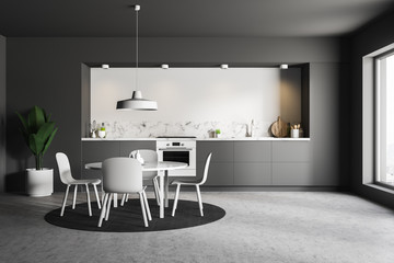 Gray and white kitchen with table