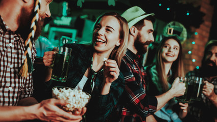 Man In Funny Hat Is Eating Popcorn With A Girl.