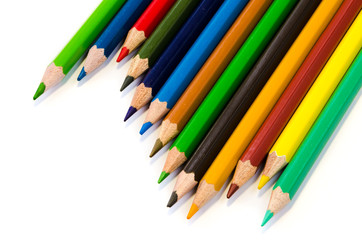 Color pencils pink light blue green yellow and red on white background.
