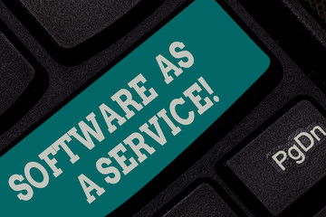 Writing note showing Software As A Service. Business photo showcasing Mobile apps and technologies assistance support Keyboard key Intention to create computer message pressing keypad idea