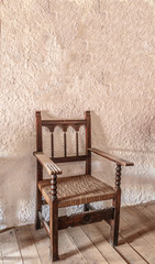 Vintage wooden chair next to a white wall