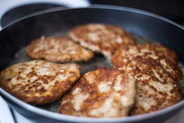 Fried meat in a pan. Fried beef cutlets for burgers. How to make a burger.