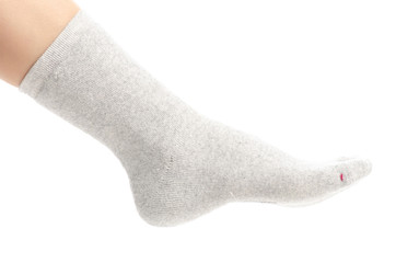 Female legs in gray socks on white background. Isolation