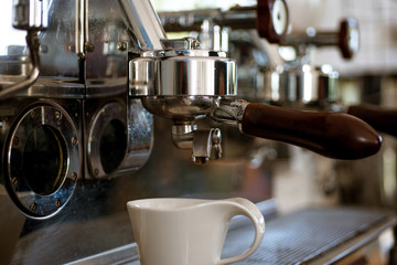 Making your drink exactly how you like. Brewing coffee in commercial coffeehouse or cafe. Coffee cup. Small cup to serve coffee or espresso drinks. Stainless steel coffee machine or coffeemaker