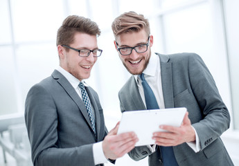 two colleagues discussing information from a digital tablet