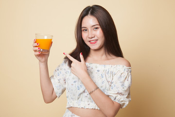 Young Asian woman point to orange juice.
