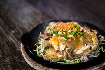 Oyster omelette in the hot pan. Thai and Chinese food.