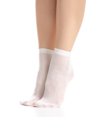 Female legs in white nylon socks on white background. Isolation