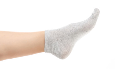Female legs in gray socks on white background. Isolation