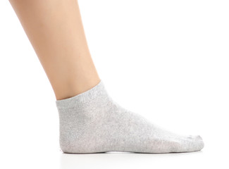 Female legs in gray socks on white background. Isolation