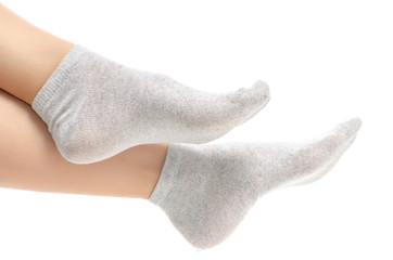 Female legs in gray socks on white background. Isolation
