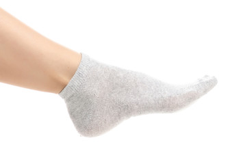 Fototapeta na wymiar Female legs in gray socks on white background. Isolation