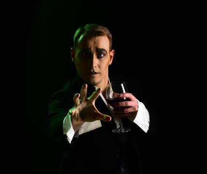Wait. Mime artist perform on stage. Stage actor pantomime drinking wine. Comedian with mime makeup hold wine glass. Drama theatre actor miming. Theatrical performance art and silen comedy. Mime man