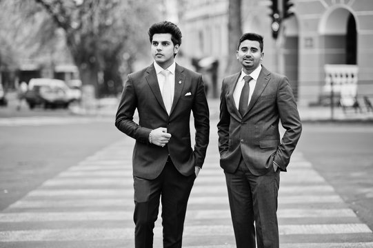 Two elegant indian fashionable mans model on suit walking at cross pedestrian.