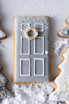 Decorated Christmas cookies arranged in a scene and dusted with confectioners sugar