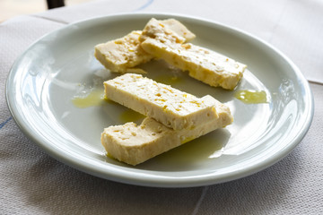 Greece, Zakynthos, Plate of white greek feta cheese strips and fresh olive oil