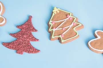 Gingerbread with Christmas tree isolated on light blue pastel background