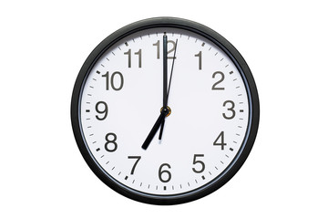 Wall clock shows time 7 o'clock on white isolated background. Round wall clock - front view....
