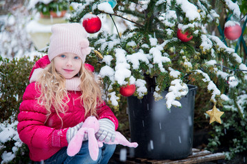 happy girl with Christmas tree outdoor