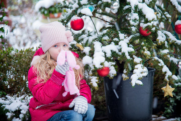 happy girl with Christmas tree outdoor