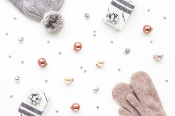 Christmas composition. Marble gift box, decorations, balls, knitted cap, mittens on white background, flat lay, top view