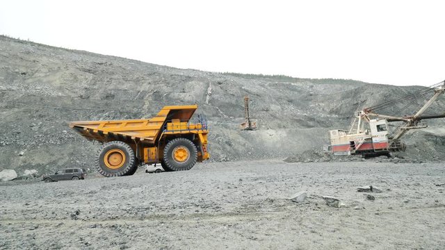 Heavy mining trucks moving on a limestone quarry. Heavy equipment.