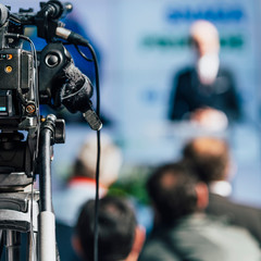 Media Event. Camera Recording Male Speaker On Stage