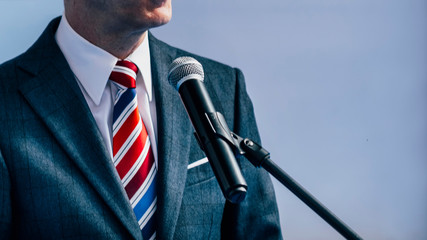 Male Businessman In Front Of Microphone