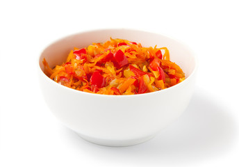 Hot carrot pepper salad, in a white bowl, isolated on a white background.
