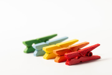 Colorful wooden clothespins on white background concept