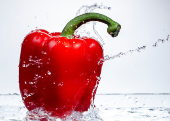 Paprika Splash in Water on white background,sweet pepper drop in the water