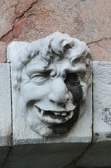 Gargoyle face on bridge Venice Italy