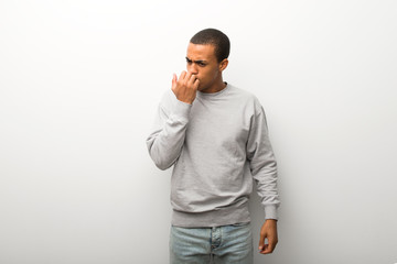 African american man on white wall background having doubts