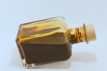 dark fluid balsamic vinegard in a small glass bottle with cork