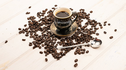 A cup of coffee and coffee beans