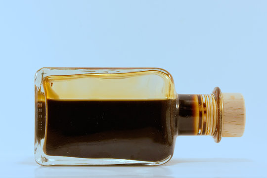 dark fluid balsamic vinegard in a small glass bottle with cork